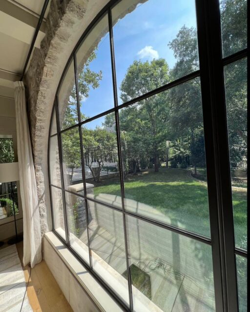 Modern elegance meets historic charm in this Charlotte, NC stone home, featuring custom Hope’s steel arched windows and a striking oversized steel pivot door — where craftsmanship and design make a bold statement. #hopeswindows #agnora #stonework #modernconstruction  #steelwindows #customdoors #architecture #moderndesign  #charlottenc #customdesign
